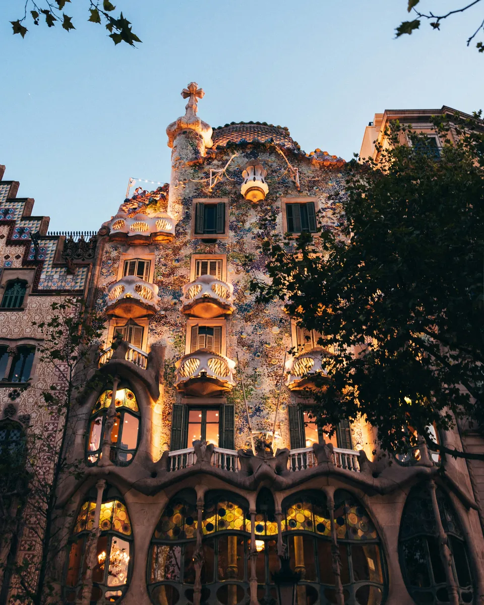 Casa Batlló's mosaic façade in Barcelona at dusk