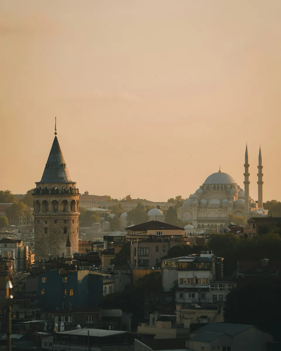 Galata Tower and a mosque dome on Istanbul's skyline in golden light